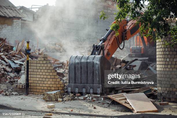 working bulldozer cleaning site from house breakdowns for new home. - slopen stockfoto's en -beelden