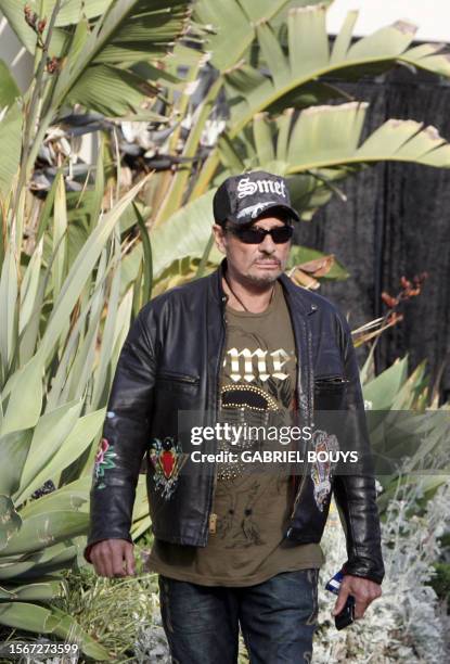 French rock star Johnny Hallyday arrives to give a private concert for the birthday of his business partner, fashion designer Christian Audigier,...