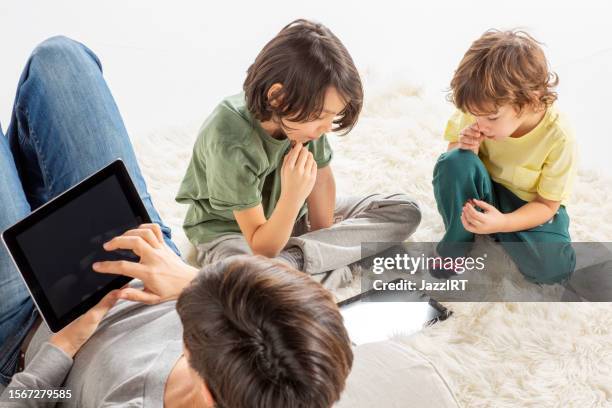 mother and her sons are using smart tablet. - convenience chocolate stock pictures, royalty-free photos & images