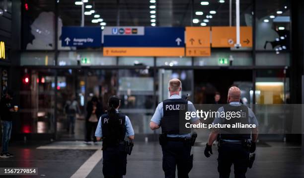 July 2023, North Rhine-Westphalia, Essen: Police officers walk through the station. After a World War II bomb was found, the rail line between Essen...