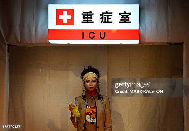 Model carries an IV bag during the "Toxic Threads - The Big Fashion Stitch-up" fashion parade organized by environment action group Greenpeace to...