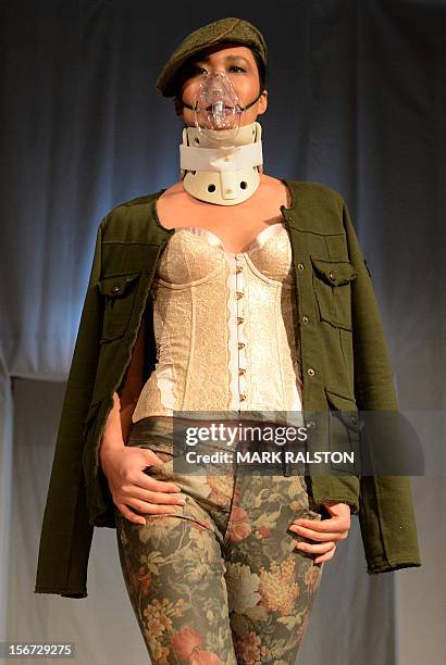 Model wears a face mask during the "Toxic Threads - The Big Fashion Stitch-up" fashion parade organized by environment action group Greenpeace to...