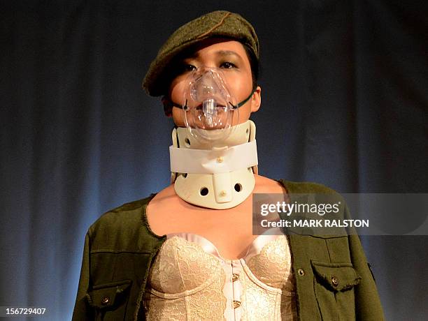 Model wears a face mask during the "Toxic Threads - The Big Fashion Stitch-up" fashion parade organized by environment action group Greenpeace to...