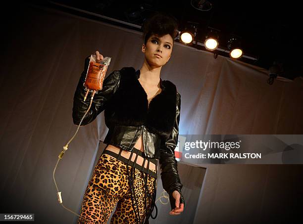 Model carries an IV bag during the "Toxic Threads - The Big Fashion Stitch-up" fashion parade organized by environment action group Greenpeace to...