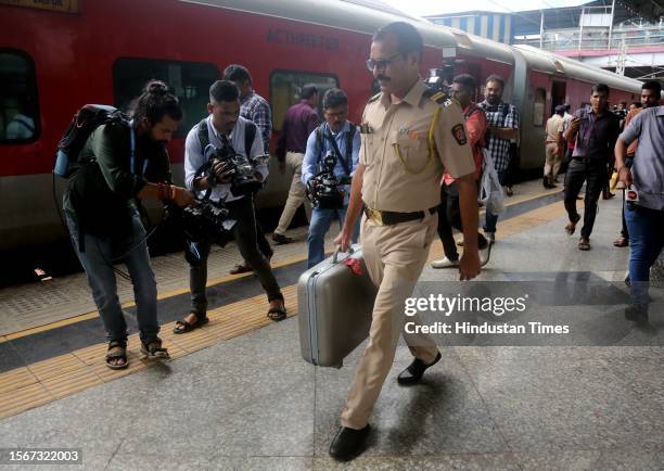 Police personnel inspect the Jaipur-Mumbai Central Express on board which a Railway Protection Force jawan shot dead four people near Palghar railway...