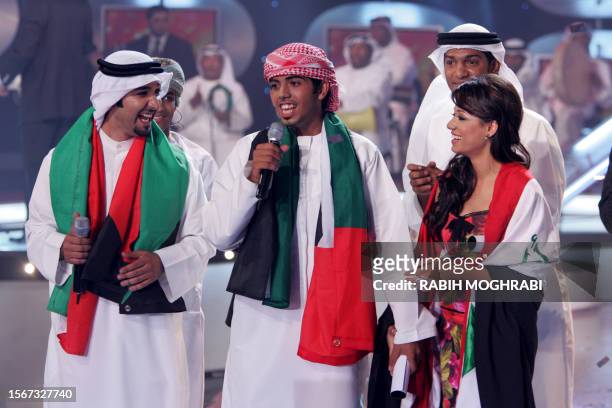 Gulf Star Emirati Moadad al-Kaabi performs among the two other finalists Iraqi Rahmah Mezher and Kuwaiti Abdullah al-Zaid during the last episode of...