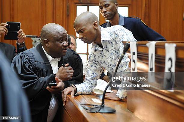 Xolile Mngeni speaks to his lawyer in the Cape Town High Court on November19, 2012 in Cape Town, South Africa. Mngeni was found guilty of robbery...