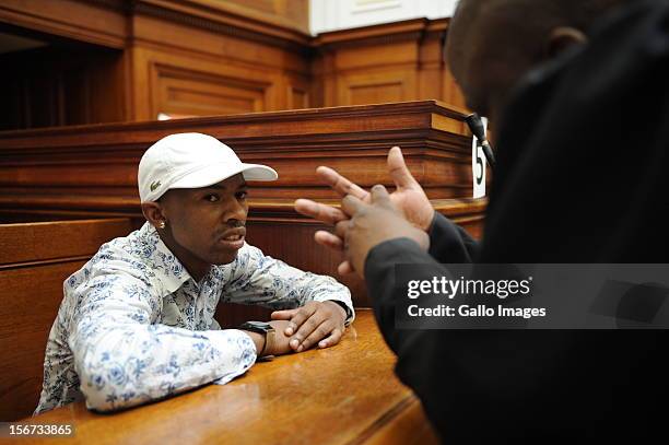 Xolile Mngeni speaks to his lawyer in the Cape Town High Court on November19, 2012 in Cape Town, South Africa. Mngeni was found guilty of robbery...