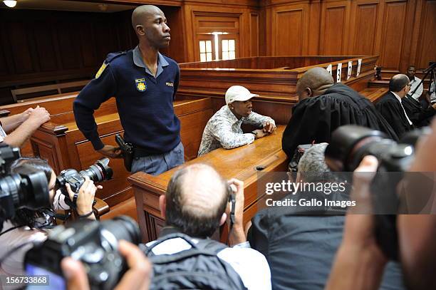 Xolile Mngeni is surrounded by photographers in the Cape Town High Court on November19, 2012 in Cape Town, South Africa. Mngeni was found guilty of...