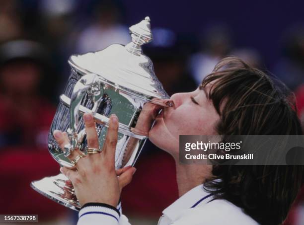 Martina Hingis from Switzerland kisses the Women's Singles Championship Trophy after defeating Venus Williams of the United States during their...