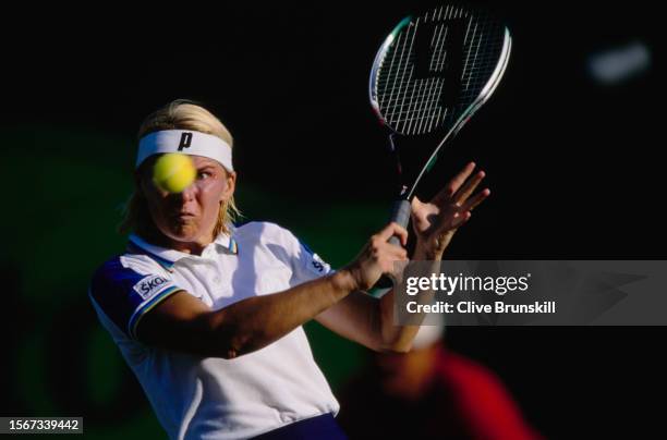 Jana Novotná from the Czech Republic keeps her eyes on the tennis ball as she plays a backhand return against Venus Williams of the United States...