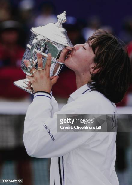Martina Hingis from Switzerland kisses the Women's Singles Championship Trophy after defeating Venus Williams of the United States during their...