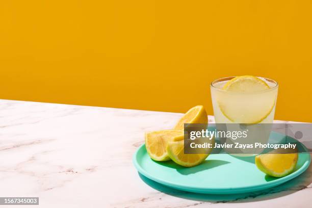 fresh homemade lemonade glass on a marble surface - marble table stock pictures, royalty-free photos & images