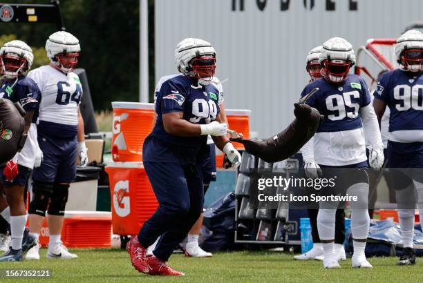 New England Patriots defensive tackle Carl Davis casts aside his heavy bag during New England Patriots Training Camp on July 30 at the Patriots...