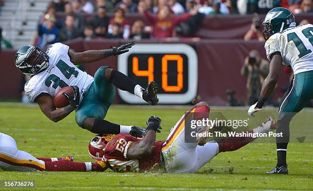 Philadelphia Eagles running back Bryce Brown is brought down by Washington Redskins inside linebacker London Fletcher after running for a first down...