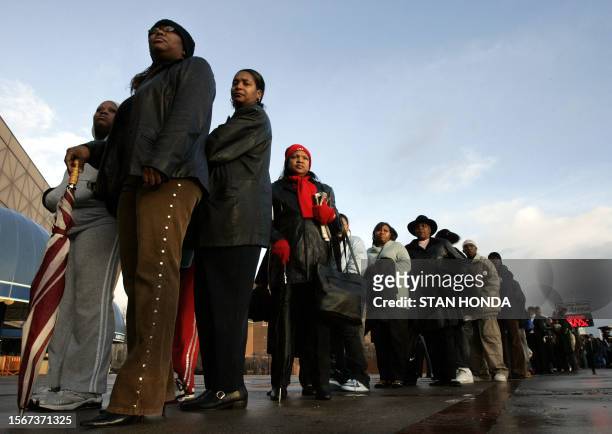 People wait in a line to view the body of soul singer James Brown, known as the "Godfather of Soul, during what is described as a "Homecoming" at the...