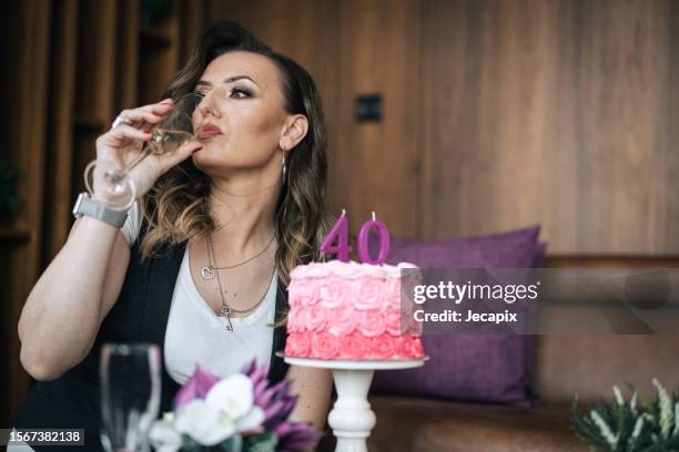 woman drinking champagne - happy 40th anniversary stock pictures, royalty-free photos & images