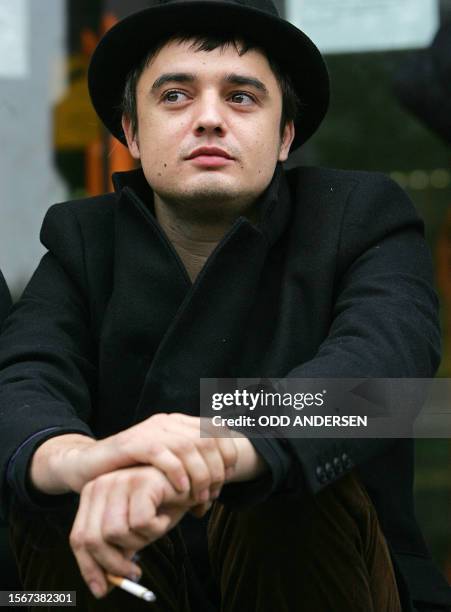 British pop singer Pete Doherty smokes a cigarette outside Thames magistrates court in east London, 08 November 2006, as he prepares to face charges...