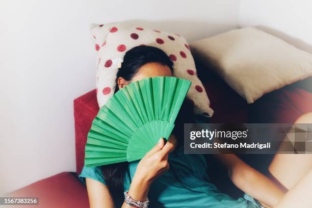 girl with a colorful folding fan for the heat - hand fan stock pictures, royalty-free photos & images