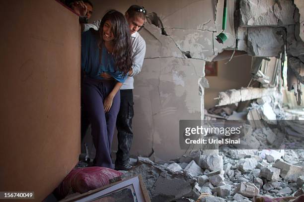 Sapir Hachmon and her boyfriend Ron Vachnish react as they enter her room after it was hit by a rocket fired from the Gaza Strip on November 20, 2012...