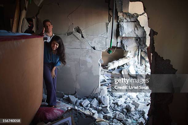 Sapir Hachmon and her boyfriend Ron Vachnish react as they enter her room after it was hit by a rocket fired from the Gaza Strip on November 20, 2012...