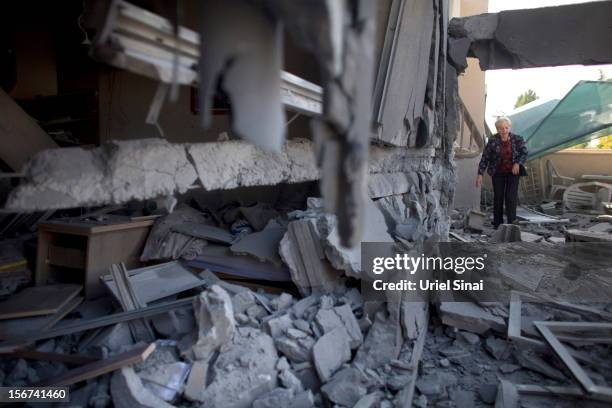 An Israeli woman inspects her house after it was hit by a rocket fired from the Gaza Strip on November 20, 2012 in Beersheba, Israel. Hamas militants...