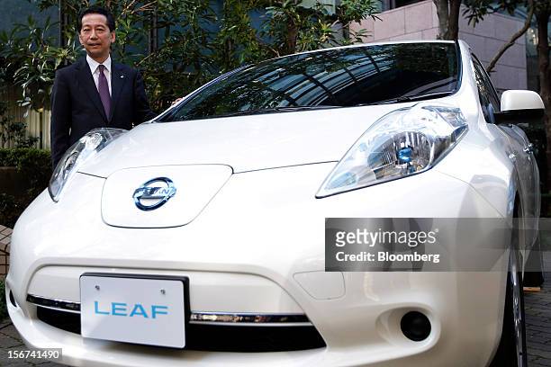 Masaaki Nishizawa, senior vice president of Nissan Motor Co., stands alongside the updated Nissan Leaf electric vehicle during a news conference in...