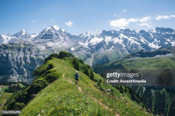 trail runner ascends alpine path in swiss mountain landscape - green high heels stock pictures, royalty-free photos & images
