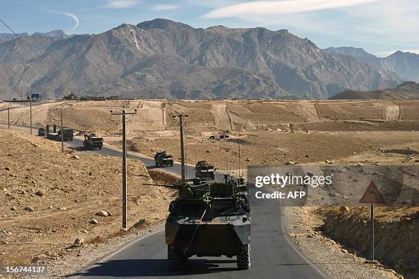 French military vehicles travel in a convoy from Nijrab to Kabul following their departure from the French military Camp Nijrab in Nijrab district of...