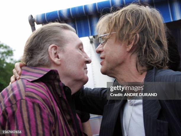 Rock legend Jerry Lee Lewis is welcomed by French singer Jean-Louis Aubert during the Terre Neuvas festival, 08 July 2006 in Bobital, western France....