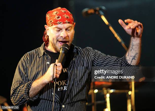 The singer of the French band Trust, Bernie Bonvoisin, performs on the stage of the Terre Neuvas festival, 08 July 2006 in Bobital, western France....