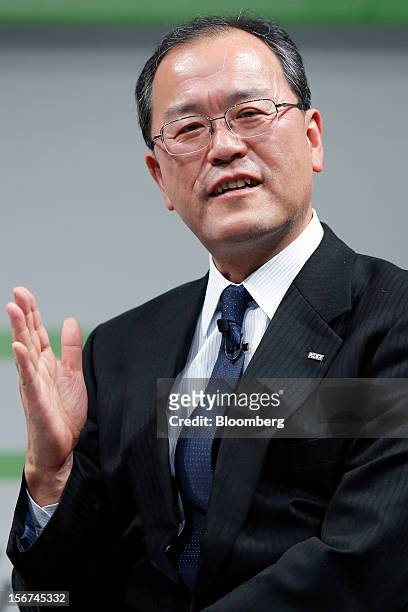 Takashi Tanaka, president of KDDI Corp., speaks during the launch of the HTC J Butterfly smartphone, produced by HTC.Corp., at the unveiling event in...