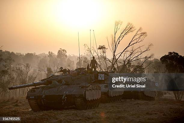 Israeli soldiers prepare weapons and vehicles in a deployment area as the conflict between Palestine and Gaza enters its seventh day on November 20,...