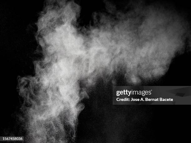 shock wave from an explosion of dust and smoke on a black background. - dampf stock-fotos und bilder