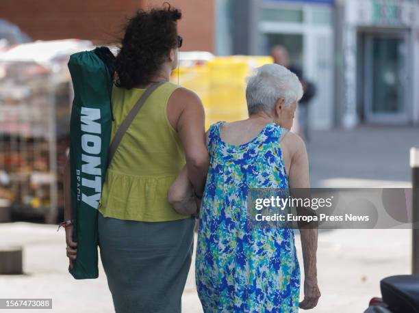 Woman walks accompanied, on 24 July, 2023 in Madrid, Spain. The population over 64 years of age in Spain is over 20% of the total and exceeds the...