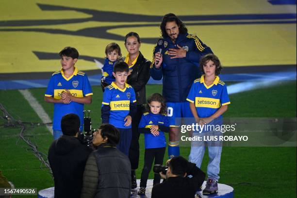 Boca Juniors' new player, Uruguayan forward Edinson Cavani, gestures next to his wife Jocelyn Burgardt and his children during his presentation at La...