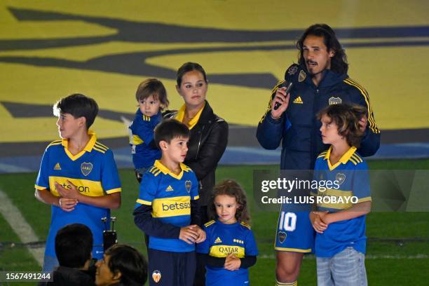 Boca Juniors' new player, Uruguayan forward Edinson Cavani, speaks next to his wife Jocelyn Burgardt and his children during his presentation at La...