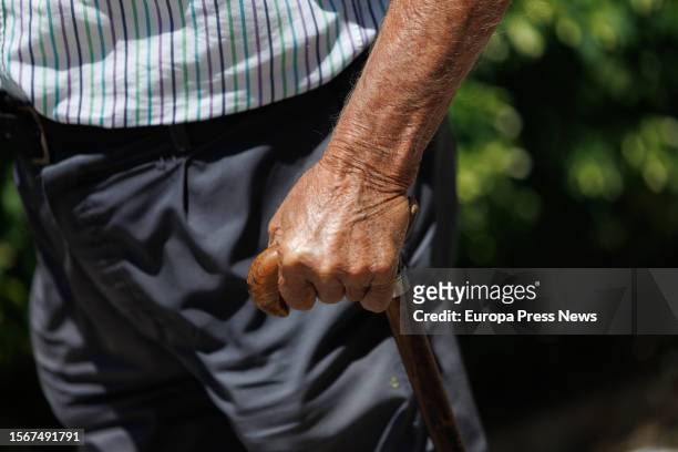 An elderly man walks leaning on a cane on July 24 in Madrid, Spain. The population over the age of 64 in Spain is over 20% of the total and exceeds...