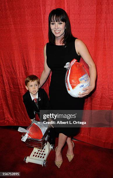 Singer Gina-Raye Carter and son Braxton arrive for Jackson Limousine Homeless Turkey Drive Red Carpet Gala held at Infusion Lounge on November 19,...
