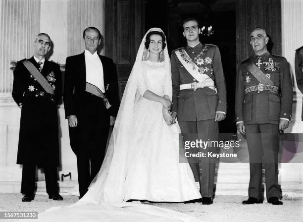 Greek Royal Princess Sophia of Greece and Denmark, wearing a wedding dress designed by Jean Desses, and Spanish Royal Juan Carlos, Prince of...