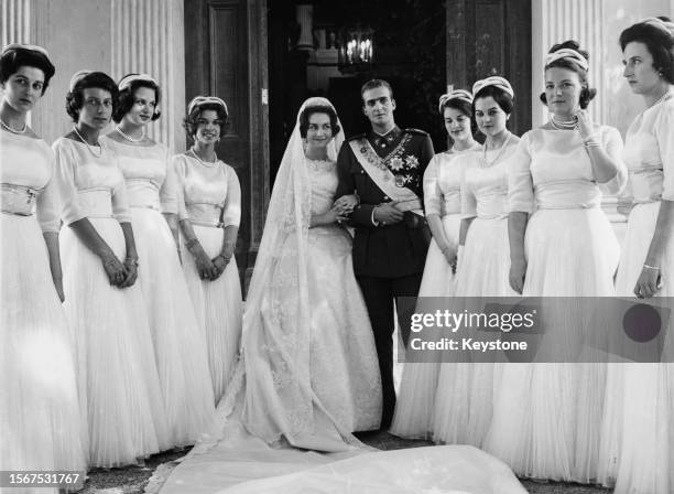 Greek Royal Princess Sophia of Greece and Denmark, wearing a wedding dress designed by Jean Desses, and Spanish Royal Juan Carlos, Prince of...