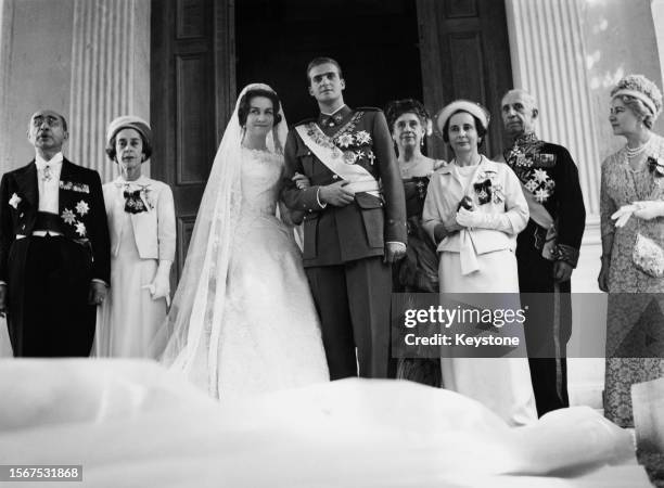 Greek Royal Princess Sophia of Greece and Denmark, wearing a wedding dress designed by Jean Desses, and Spanish Royal Juan Carlos, Prince of...