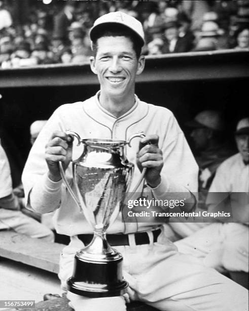 Lefty Grove, pitcher for the Philadelphia Athletics, holds his Most Valuable Player trophy in 1932 in Shibe Park, Phildelphia, Pennsylvania.
