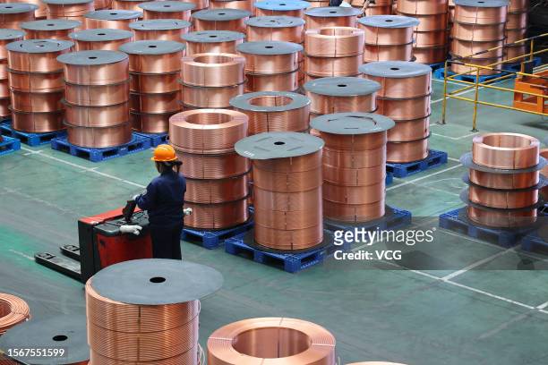 An employee works on the production line of copper tubes at a factory of Golden Dragon Precise Copper Tube Group Inc. On July 21, 2023 in Chongqing,...