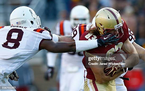 Alex Amidon of the Boston College Eagles has his facemask grabbed by Detrick Bonner of the Virginia Tech Hokies during the game on November 17, 2012...