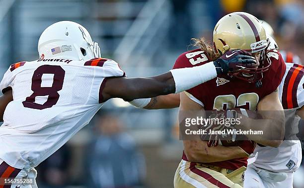 Alex Amidon of the Boston College Eagles has his facemask grabbed by Detrick Bonner of the Virginia Tech Hokies during the game on November 17, 2012...