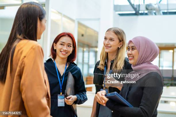 group of business people having casual conversation - south east asia people stock pictures, royalty-free photos & images