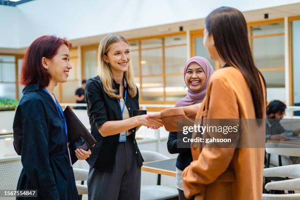 teilnehmer brechen das eis bei konferenzveranstaltung - diplomat stock-fotos und bilder