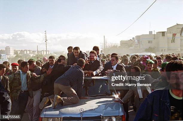 King Abdullah II of Jordan is photographed for Life Magazine in 2000 in Ma'an, Jordan. As a man jumps out of the crowd and tries to block the car,...