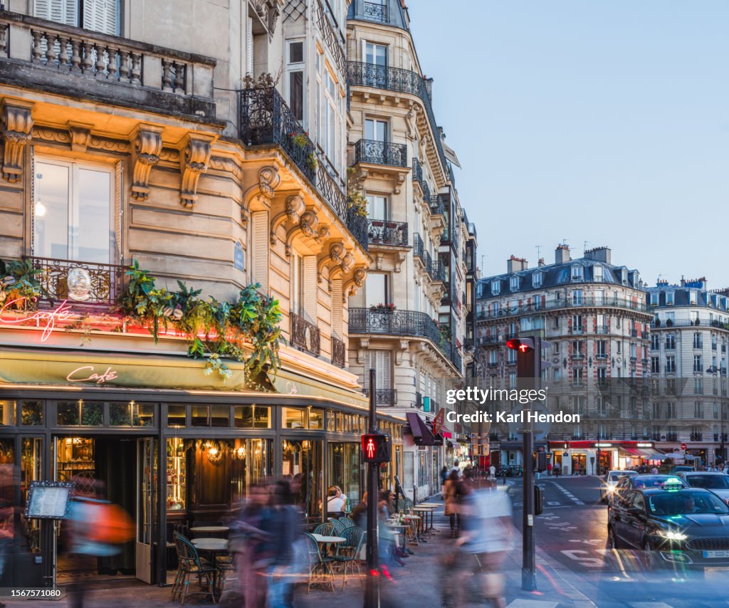 A Paris cafe and streets at dusk